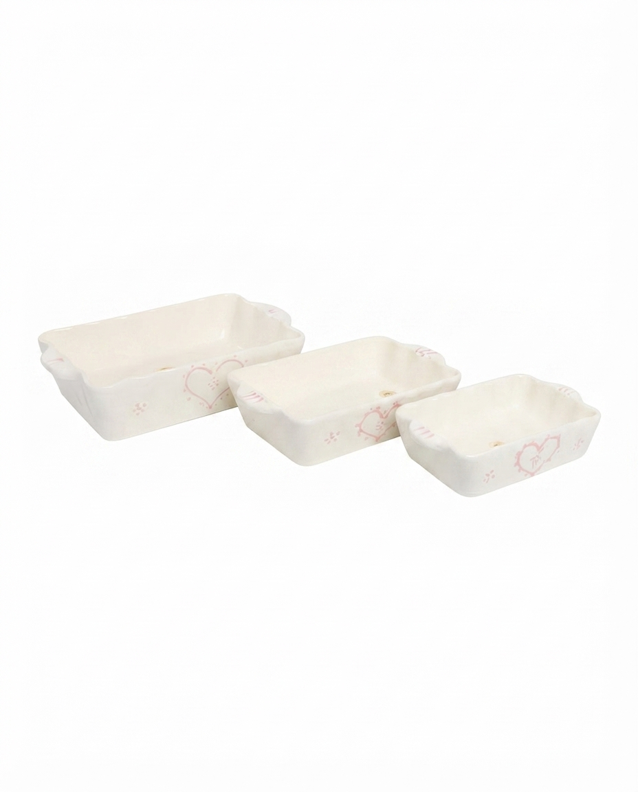 hand painted heart pattern and wavy carry handles on a medium ceramic bakeware dish