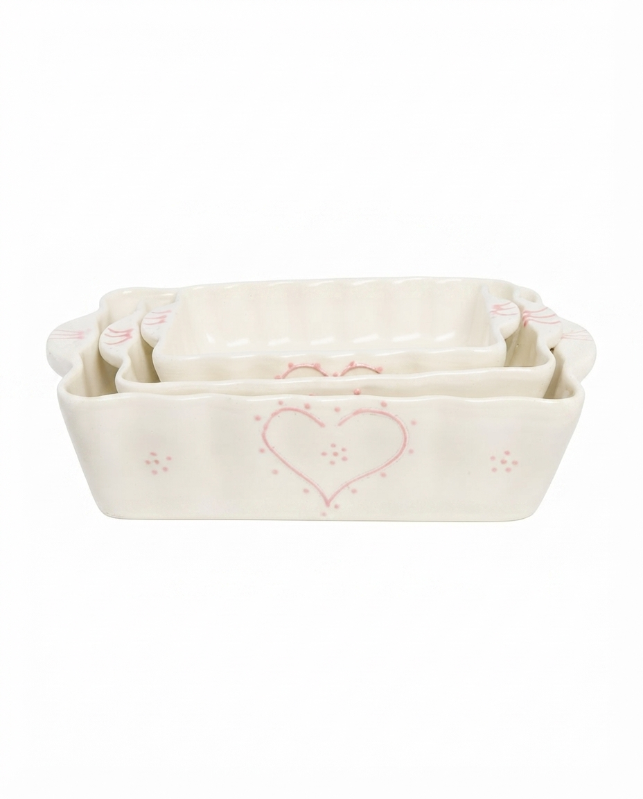 Allegria Heart You Bakers medium white ceramic baking dish with pink hearts on a clean background