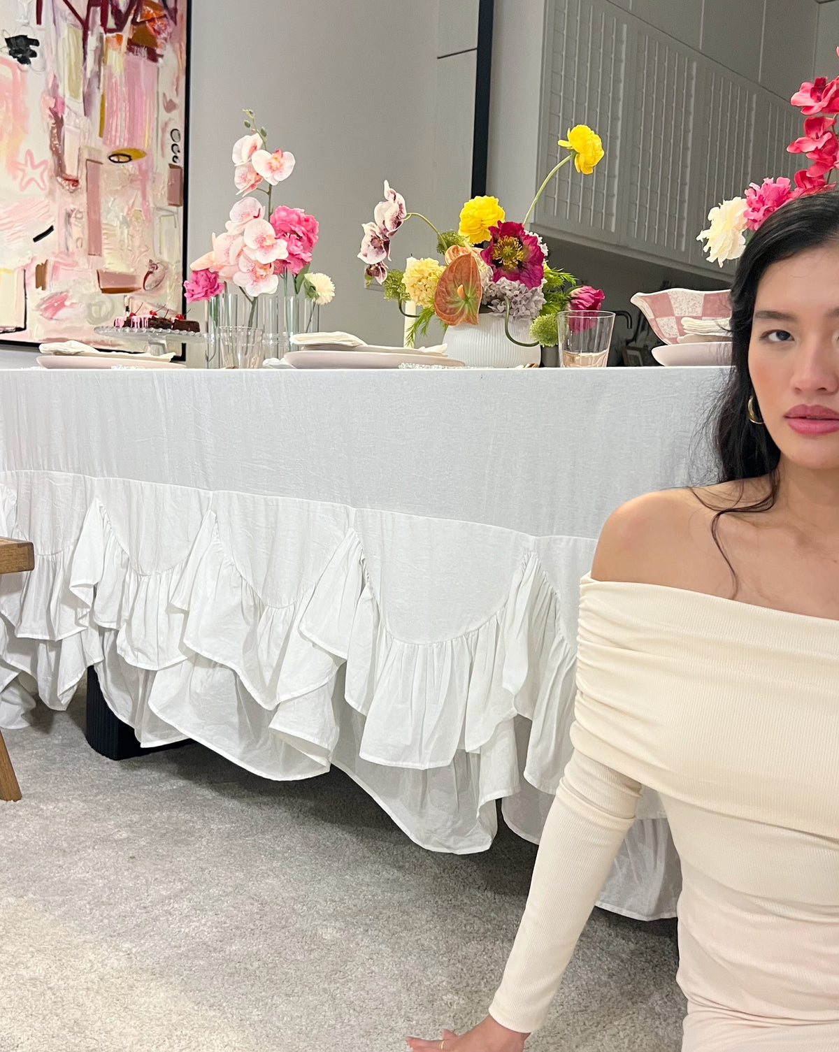Allegria white Amélie Scalloped Edge Tablecloth showing the deep gathered ruffle skirt drape on a rectangular table