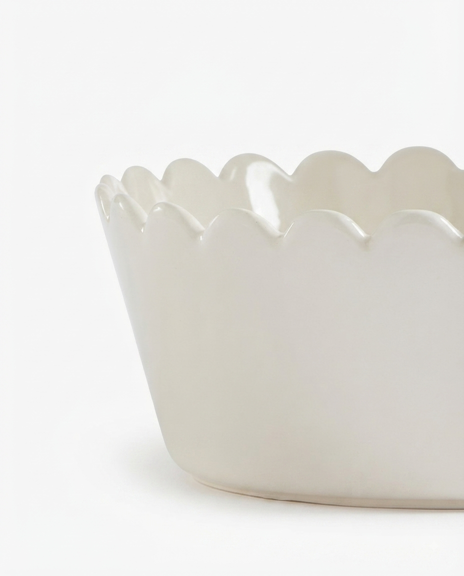 Close up view of the smooth glazed ceramic texture and 20cm round petal outline on a salad serving dish