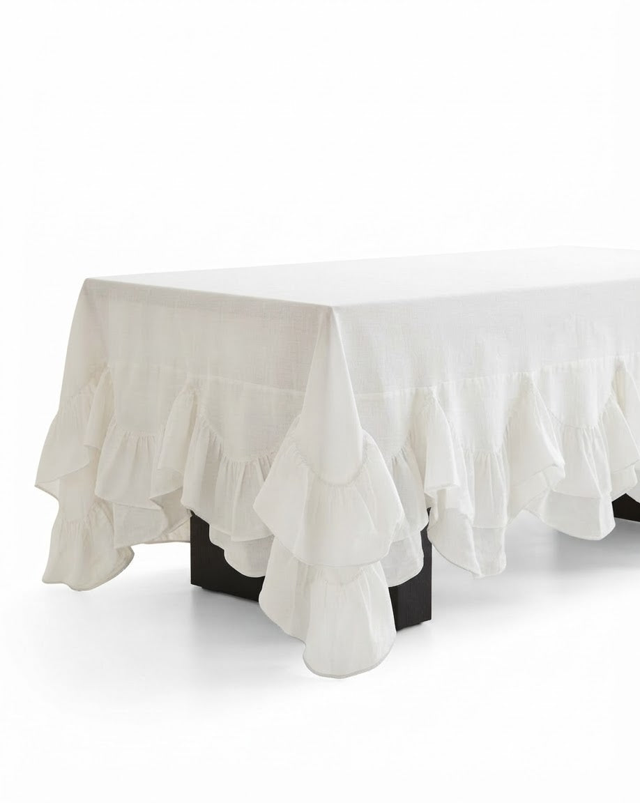 Allegria white Amélie Scalloped Edge Tablecloth styled as a premium dinner party canvas centerpiece featuring a deeply gathered fluid ruffle skirt drape.