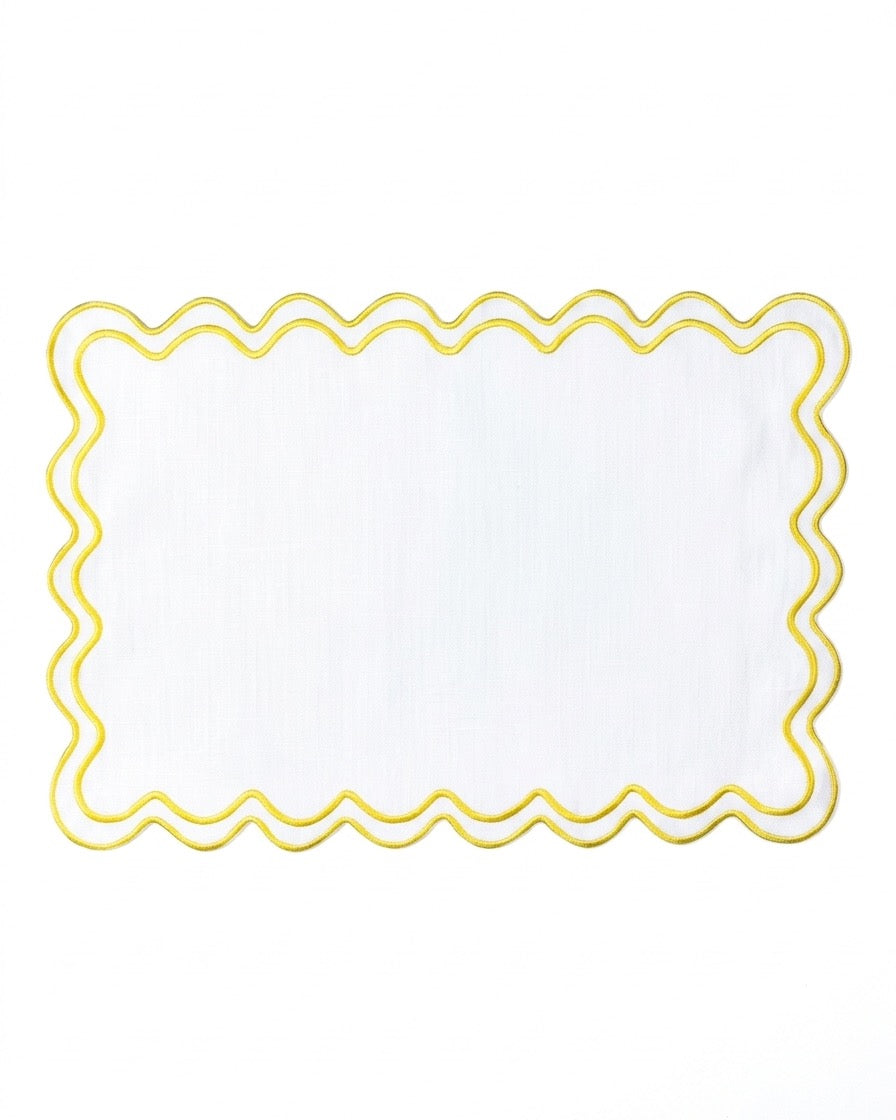 A white rectangular placemat with a scalloped edge and a yellow border, shown flat against a white background.