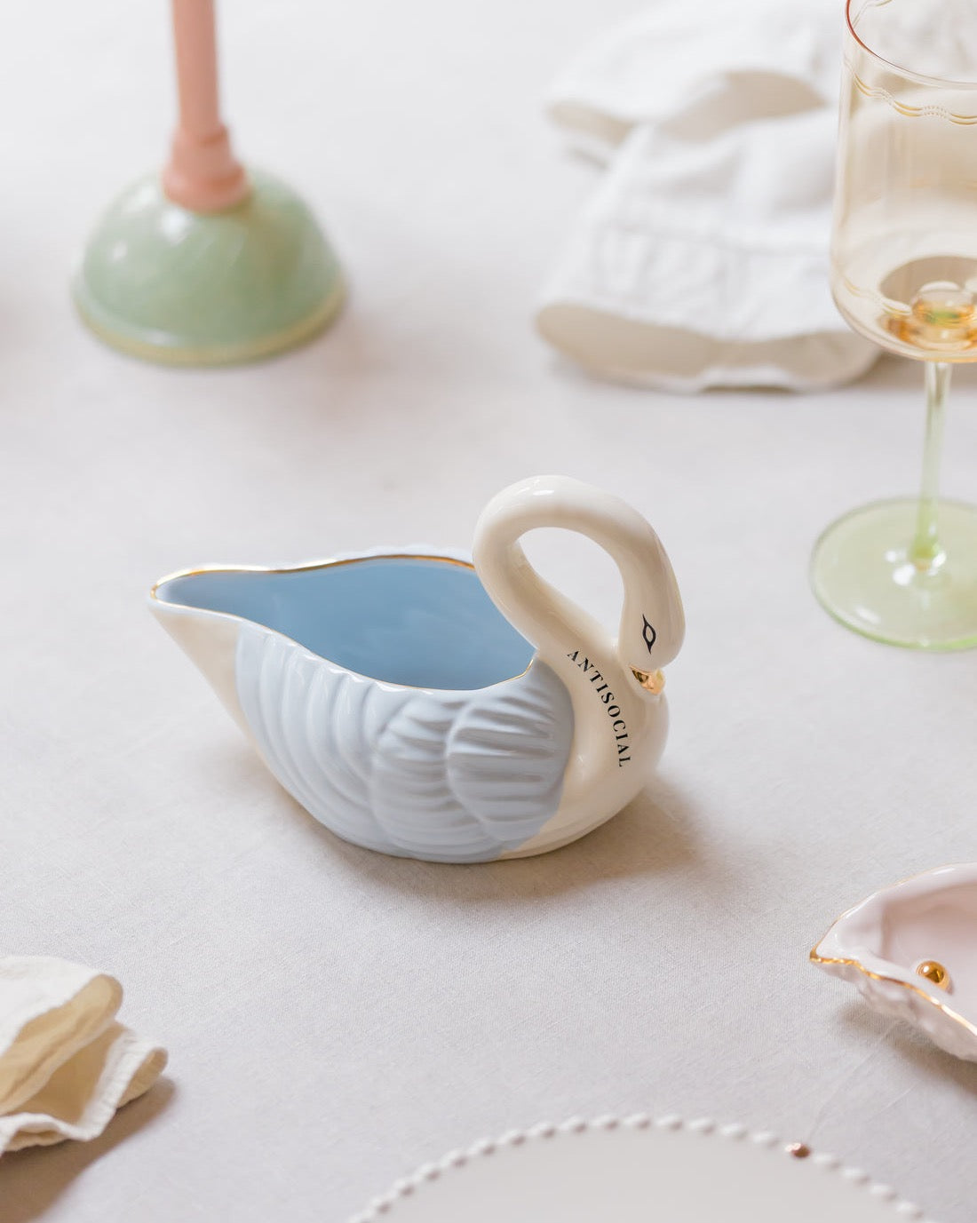 Aesthetic swan shape ceramic server styled on a dining table for a family holiday dinner gathering